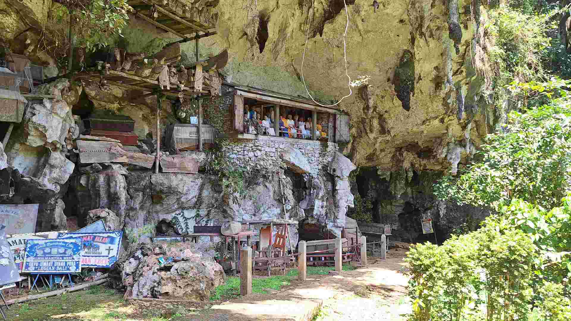 Tau-tau dolls, coffins, and more artifacts at the entrance of Londa Cave, Tana Toraja