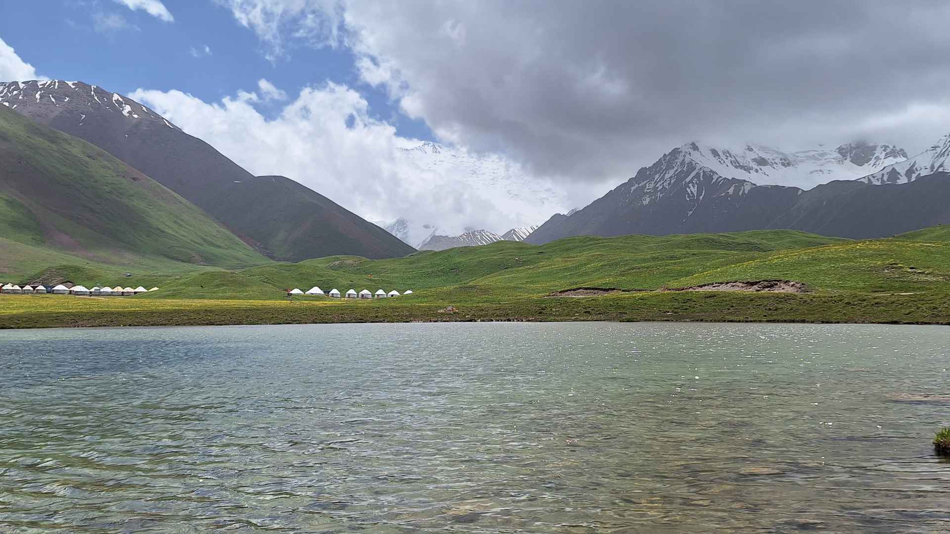 Lake Tulpar, the yurt camps and Lenin Peak in the background
