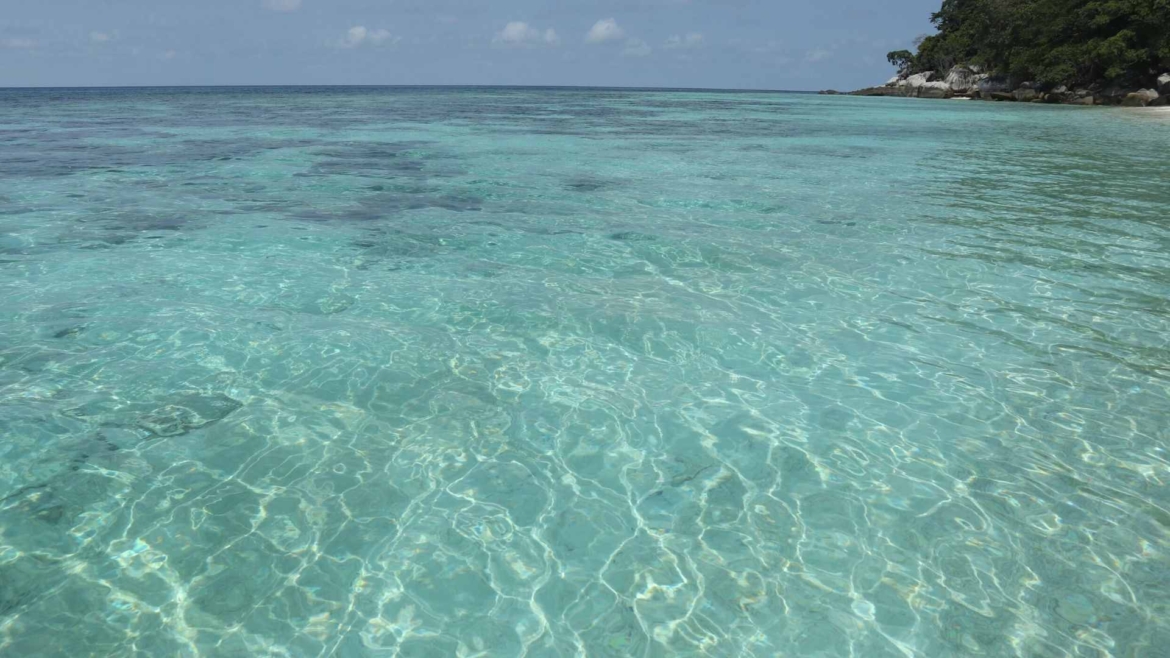 Crystal clear water around Coral Island